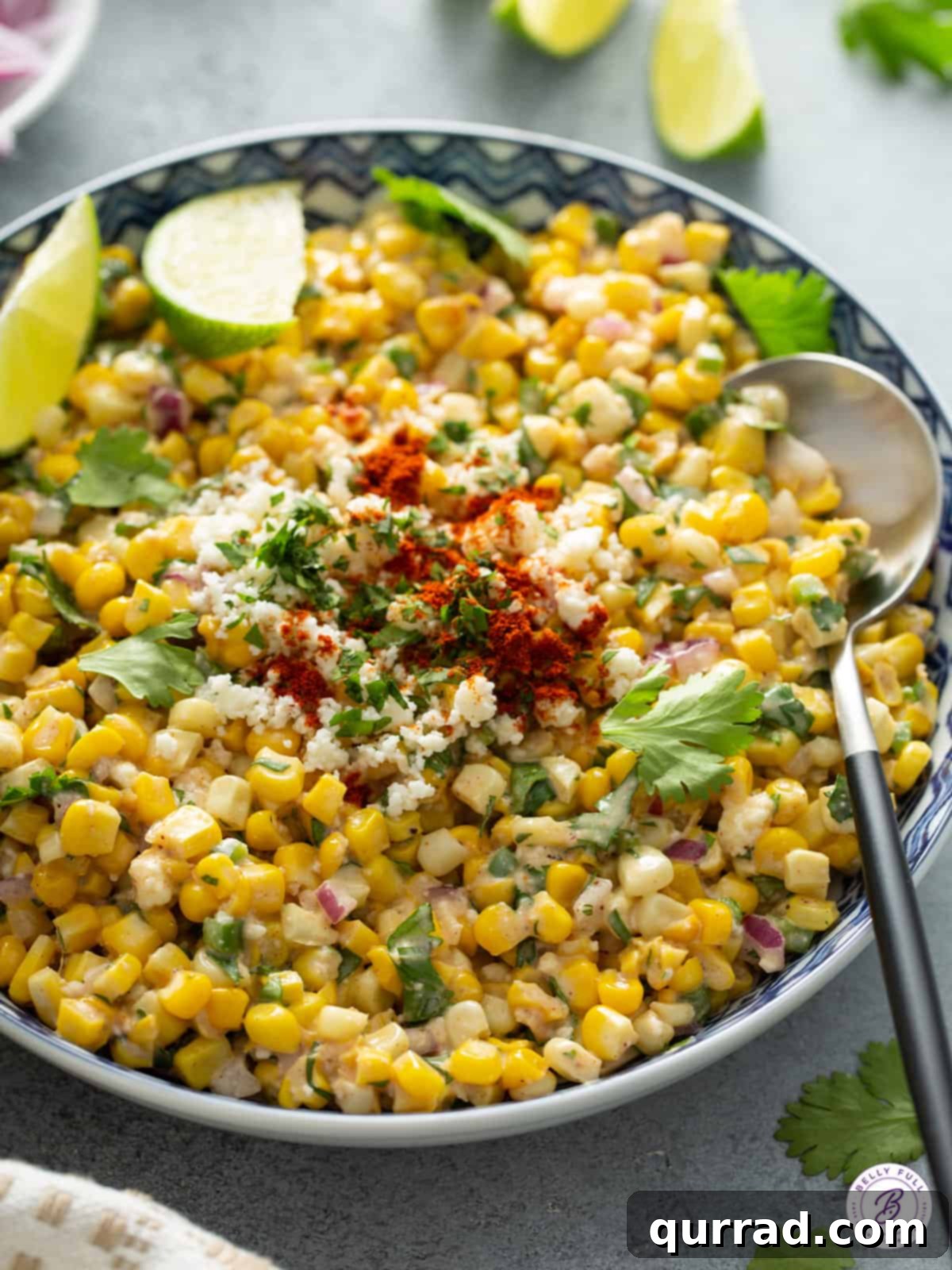 Creamy Cotija Esquites Bowl 6 A serving of Mexican corn salad in a bowl, garnished with fresh cilantro.