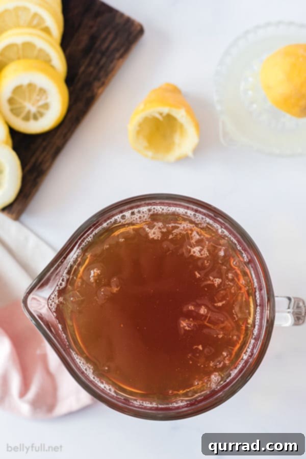 Southern Sweet Tea Classic 3 Overhead view of a pitcher filled with freshly brewed sweet tea, ready to be served, highlighting its rich color.