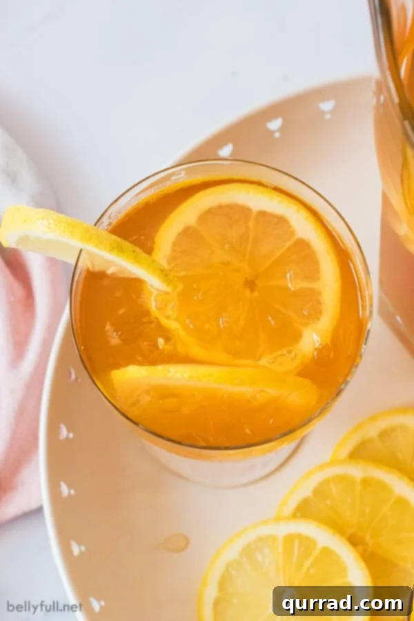 Southern Sweet Tea Classic 4 Overhead view of a single glass of sweet tea with lemon slices and ice, emphasizing its refreshing quality.