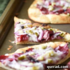 wedge of Hot Pastrami Flatbread on baking sheet