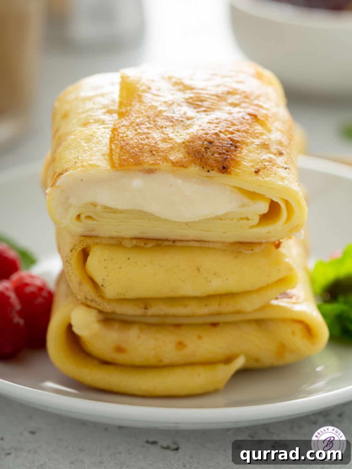 Blintz Bliss 13 A close-up shot of three creamy cheese stuffed crepes, perfectly golden-brown.