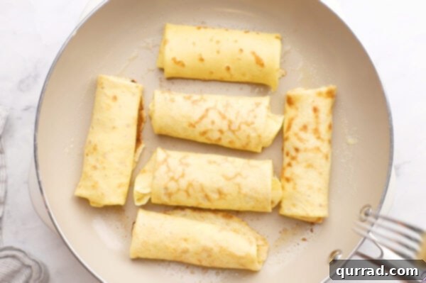 Blintz Bliss 9 Six blintzes cooking in a nonstick frying pan.