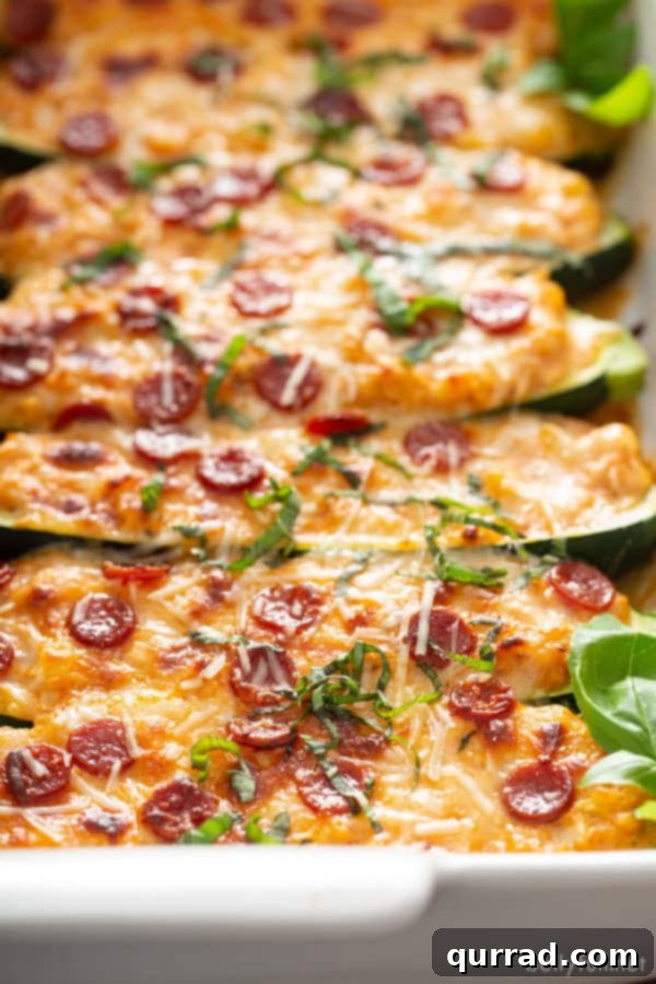 Pizza-Loaded Zucchini Boats 4 baked pizza stuffed zucchini boats in white casserole dish