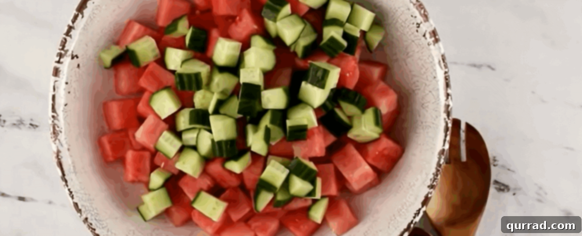 Cooling Watermelon Feta Salad 5 Combining watermelon and cucumber in a bowl.