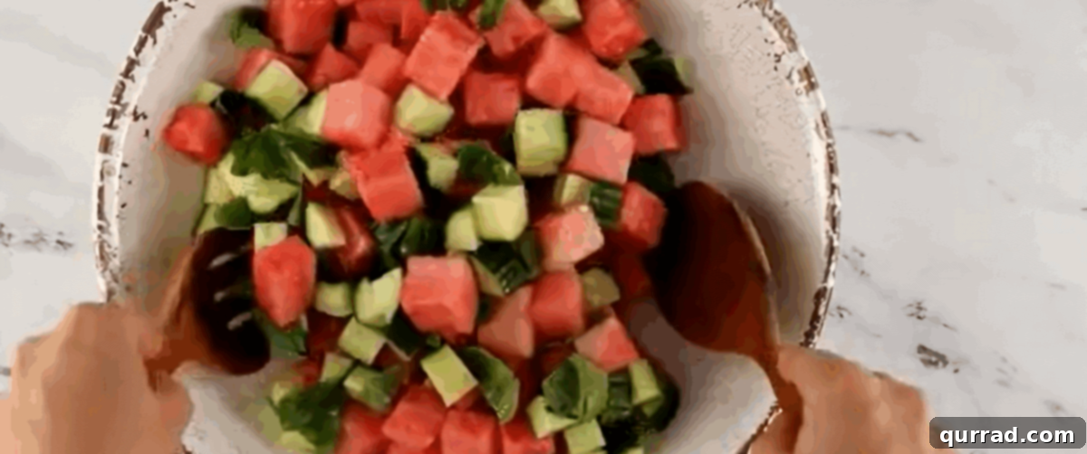Cooling Watermelon Feta Salad 6 Tossing the watermelon and cucumber with the dressing.