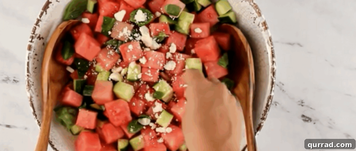 Topping the salad with feta cheese.