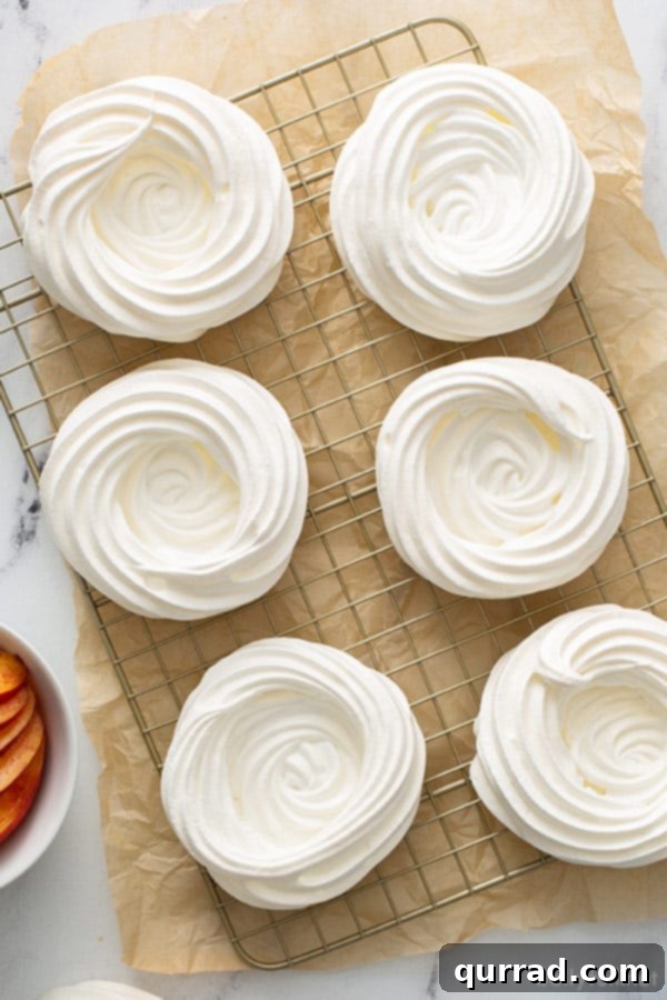 Perfect Mini Pavlova Bites 3 overhead of 6 baked mini pavlovas, unfilled, on cooling rack