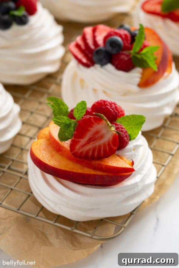 Perfect Mini Pavlova Bites 5 mini pavlova meringue with sliced fresh fruit on cooling rack