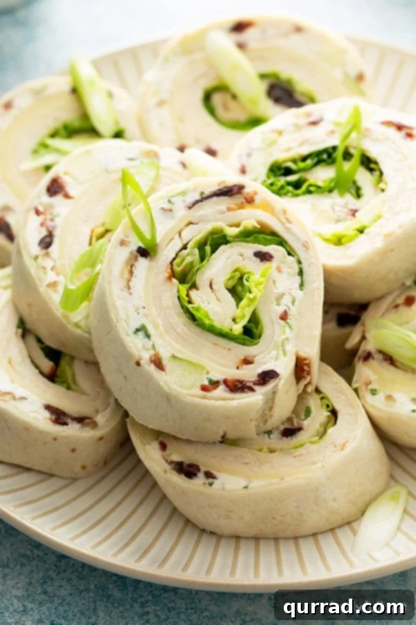 Spiral Chicken Salad Bites 2 Chicken salad tortilla roll ups on plate, showcasing vibrant colors and fresh ingredients.
