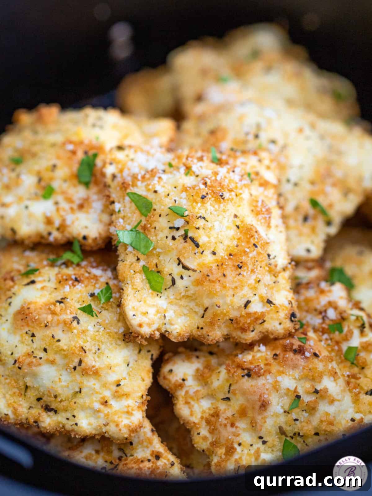Crispy Air Fryer Ravioli Bites 6 A generous pile of crispy air-fried toasted ravioli, beautifully golden brown and ready for dipping.