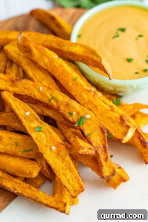 Crispy Sweet Potato Fries Air Fryer or Oven 4 A close-up photograph of perfectly cooked sweet potato fries, highlighting their vibrant golden-brown color and irresistible crispy texture.
