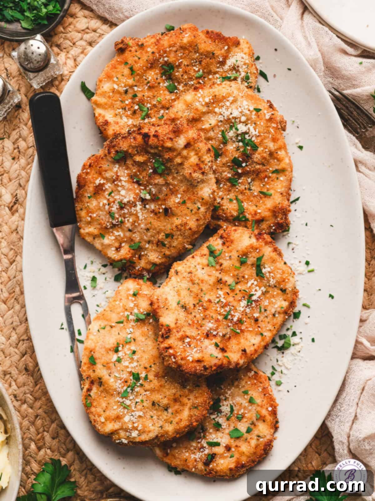 Crispy Air Fryer Pork Chops 2 Crispy breaded air fryer pork chops served on a platter, ready to eat