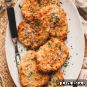 Close-up of golden-brown air fried pork chops on a serving plate