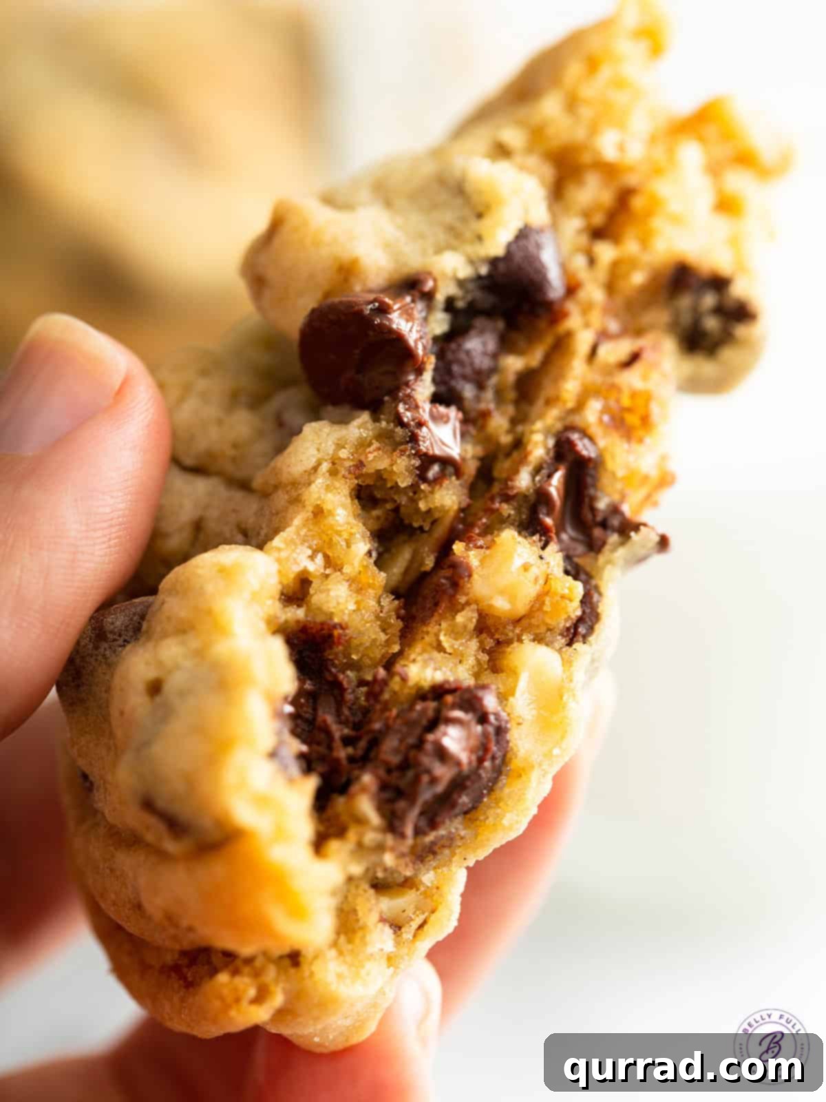 The Signature Hotel Treat 8 A close-up of a DoubleTree Cookie perfectly split in half, revealing its gooey chocolate chips and soft, chewy interior.