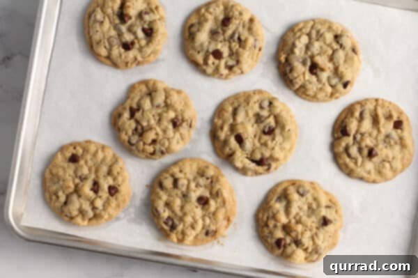 baked chocolate chip cookies on parchment paper lined baking sheet