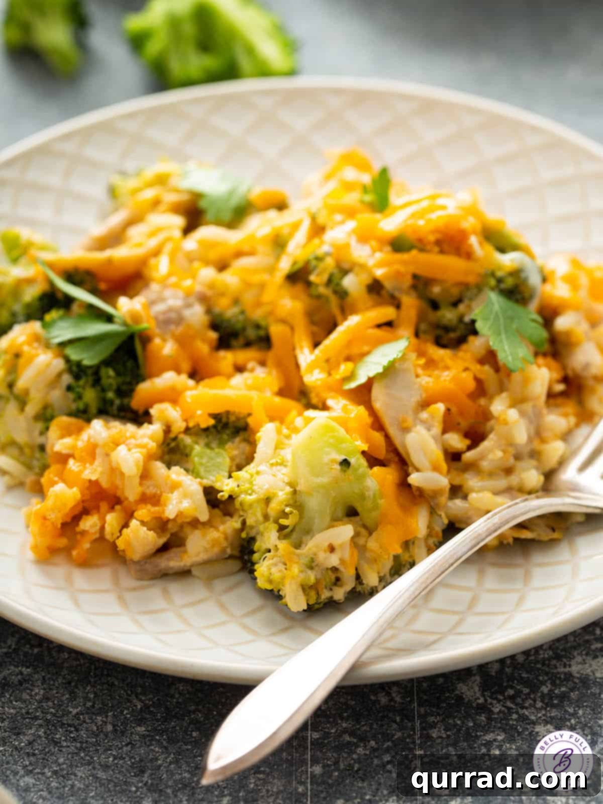 Hearty Chicken Broccoli Rice Bake 5 portion of creamy chicken and rice on plate with fork