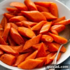 Golden Roasted Carrots 3 Close-up of golden brown roasted carrots in a bowl, garnished with fresh herbs, ready to be served.