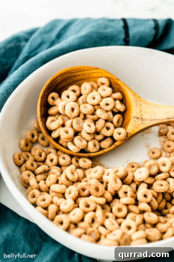 Hot Buttered Doughnut O's 3 hot buttered o's in white serving dish on wooden spoon