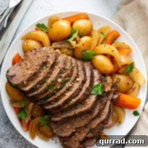 Slow Cooker Pot Roast with vegetables and gravy on a plate