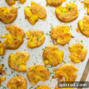 overhead of roasted smashed potatoes on baking sheet