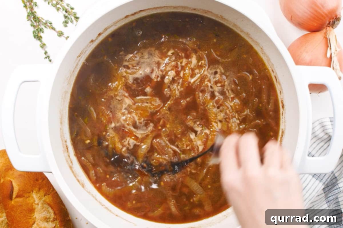 balsamic vinegar being added to french onion soup