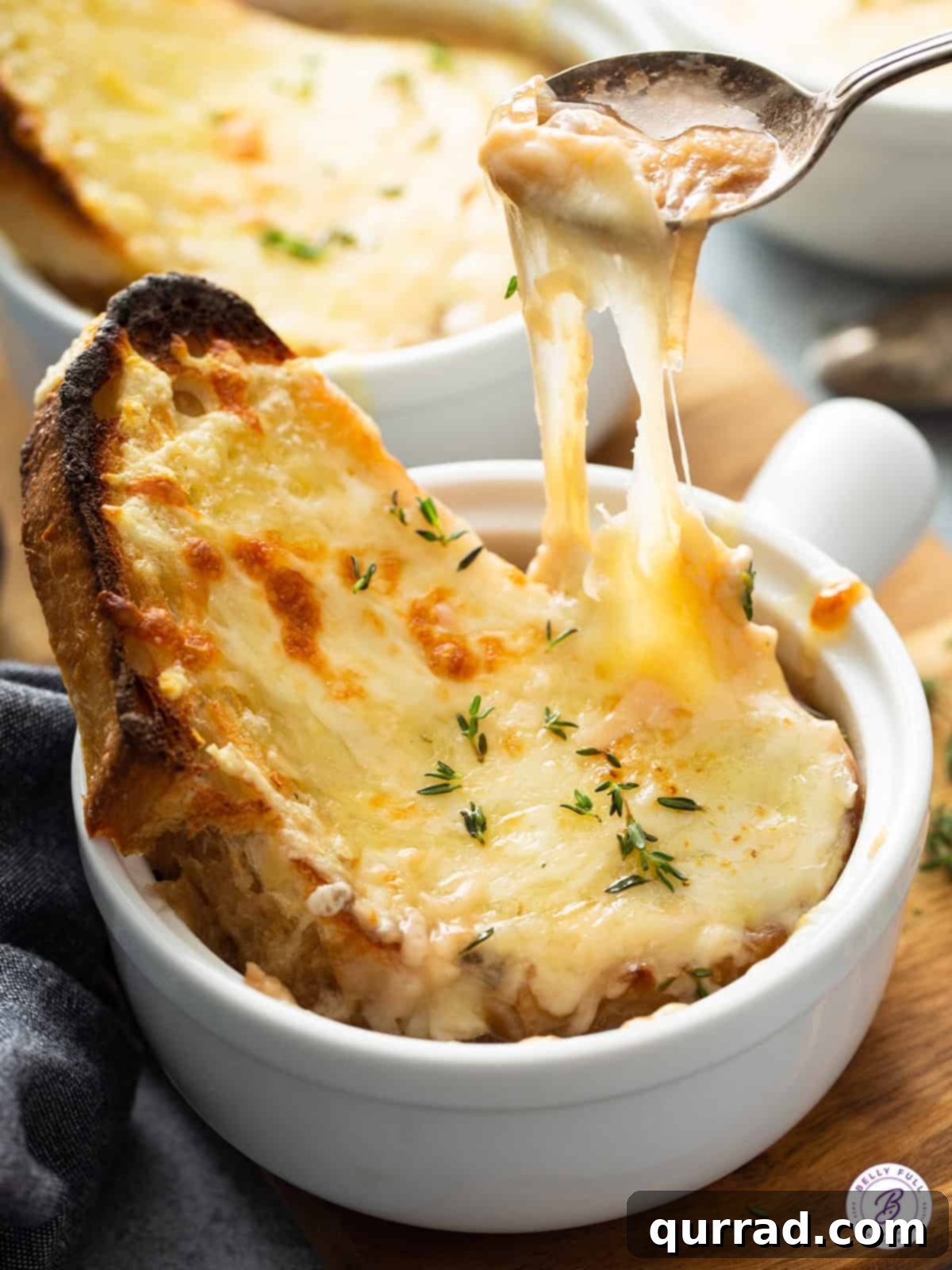 spoonful of soup with cheesy bread pull