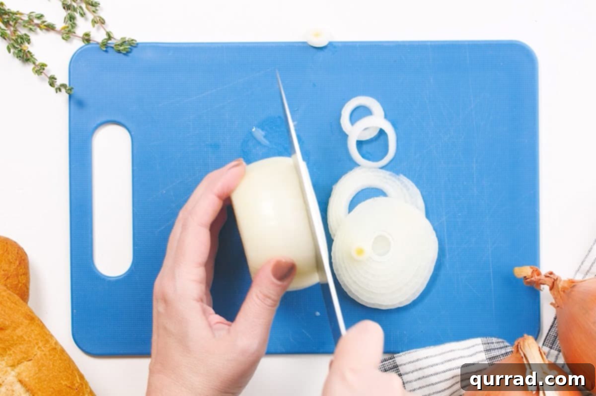 onions being sliced on cutting board