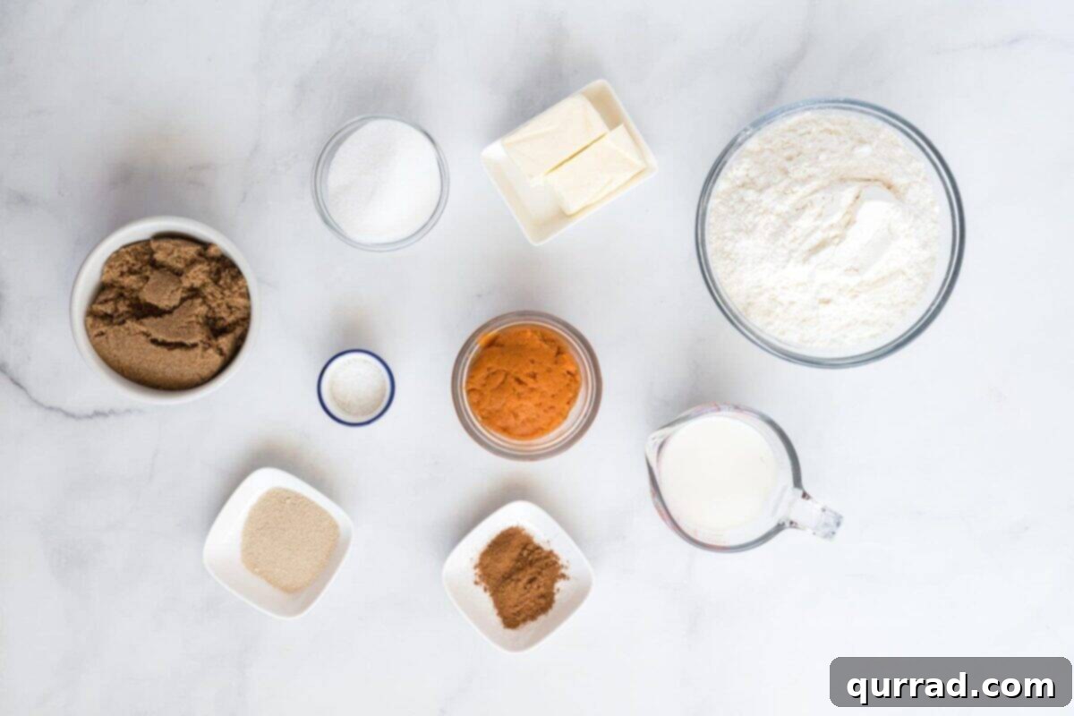 Autumn Spice Pumpkin Rolls 4 All the necessary ingredients laid out neatly on a counter, ready to be used for making pumpkin cinnamon rolls.