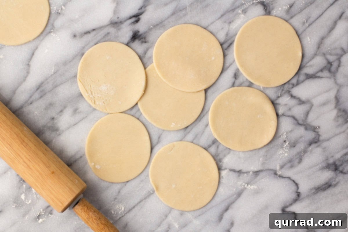 Bite-sized Pumpkin Delights 5 Mini 3.5-inch circular pie crusts cut out from rolled dough.