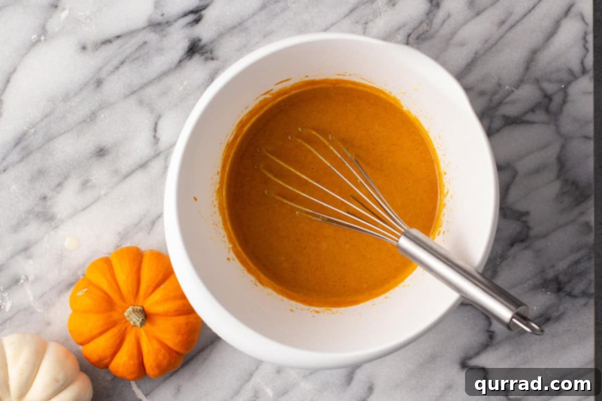 Bite-sized Pumpkin Delights 7 Pumpkin pie filling being whisked in a bowl with a whisk.