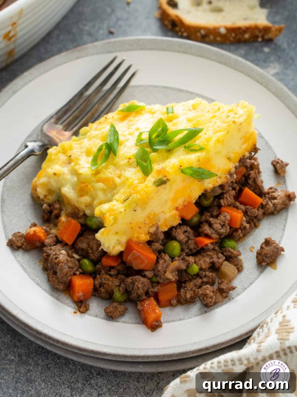 Rustic Lamb and Potato Bake 6 portion of shepherd's pie on plate with fork