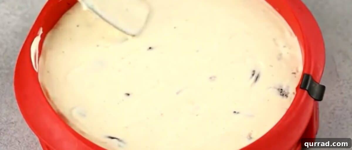 Decadent Oreo Cheesecake 8 Cheesecake batter poured evenly into the chilled Oreo crust within the springform pan.