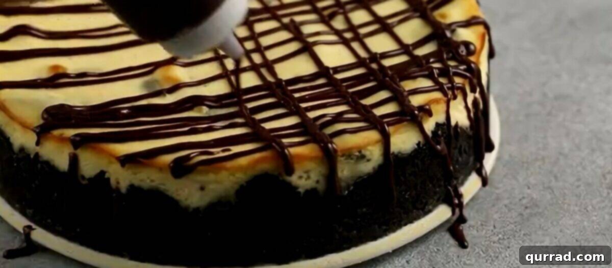 Decadent Oreo Cheesecake 10 Drizzling rich chocolate ganache over the cooled, unmolded Oreo cheesecake, creating an appealing pattern.