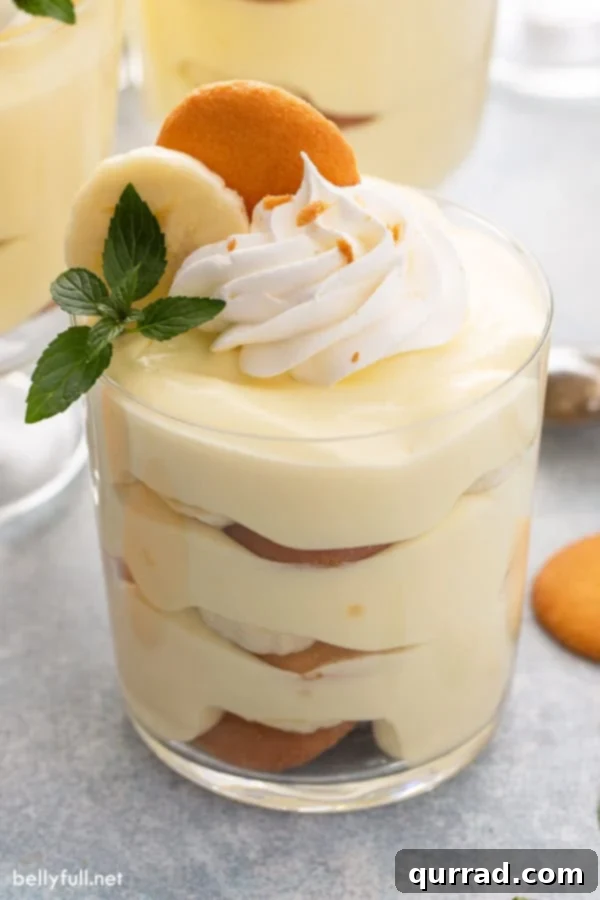 layered banana pudding in parfait glass with whipped cream