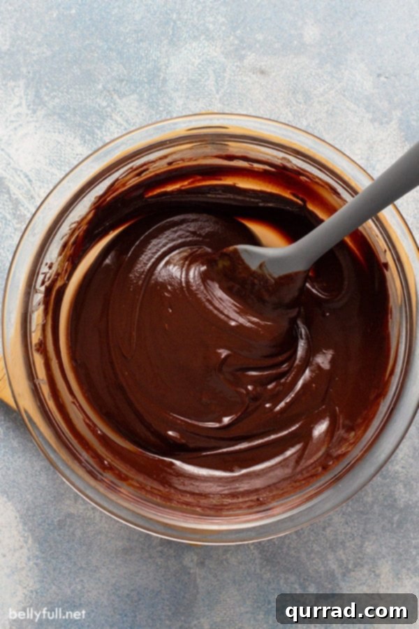 Decadent Bailey's Truffles 4 A bowl filled with silky smooth, rich chocolate ganache, ready to be chilled and transformed into delicious truffles.
