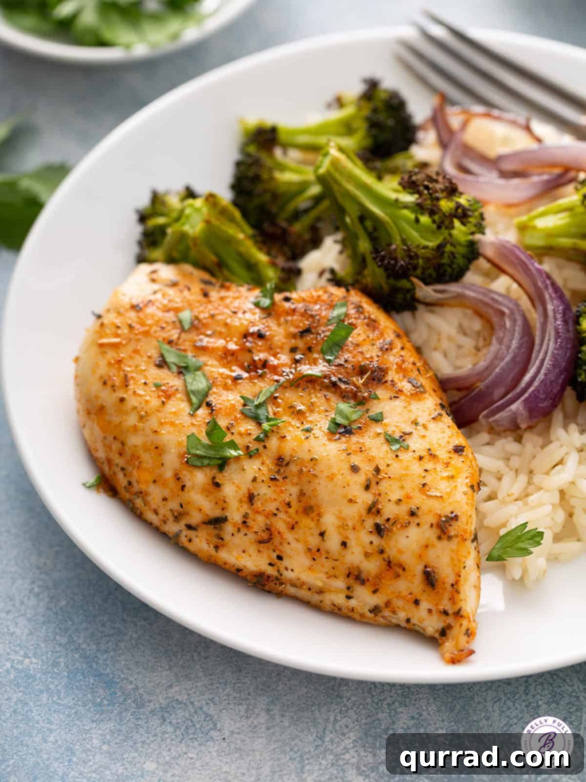 uncut whole seasoned baked chicken breast on plate