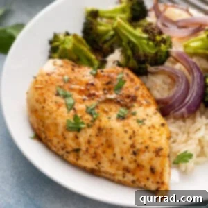 Perfectly seasoned and baked chicken breast on a plate, ready to be served.