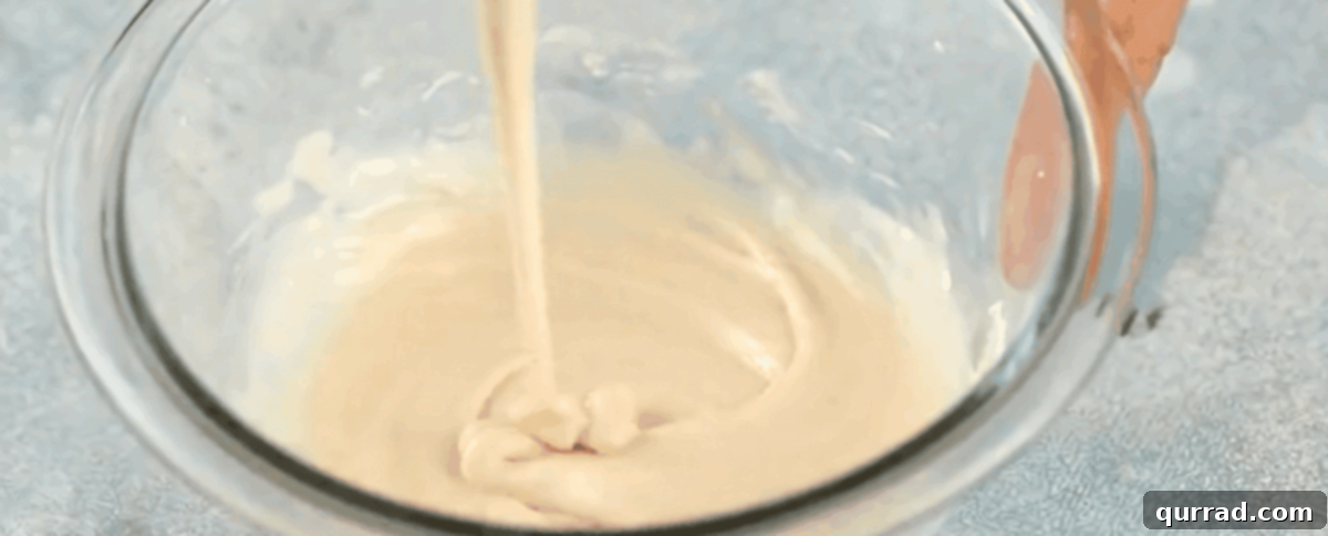Quick Air Fryer Donut Delight 7 Making the glaze for the donuts in a glass bowl.