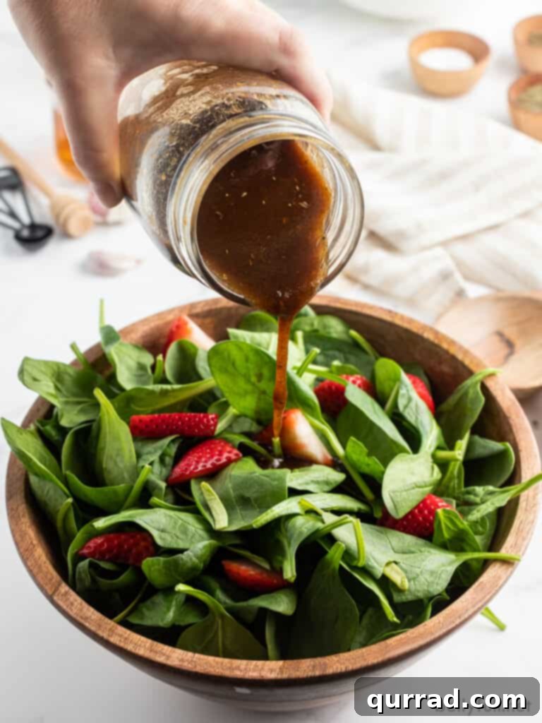 Velvet Balsamic Elixir 4 Balsamic dressing pouring out of jar onto salad