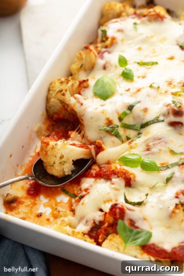 Golden Roasted Parmesan Cauliflower 3 baked cauliflower with marinara sauce and cheese on spoon