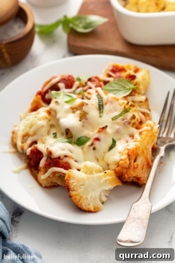 Golden Roasted Parmesan Cauliflower 5 roasted cauliflower covered in marinara sauce and melted cheese on plate