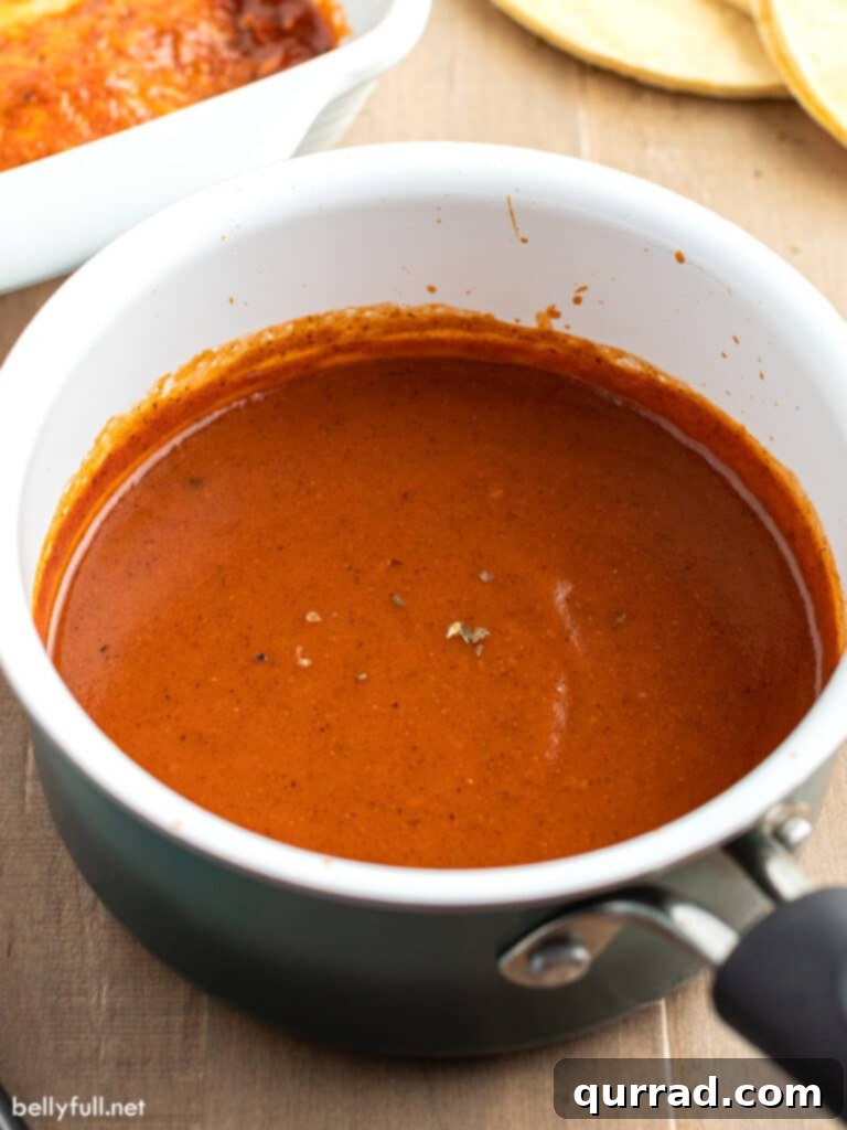 Authentic Homemade Enchilada Sauce 3 Red enchilada sauce simmering in a saucepan