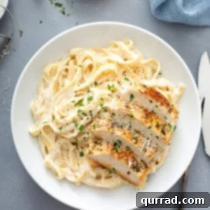 Ultimate Chicken Alfredo 3 overhead of Chicken Alfredo serving on white plate
