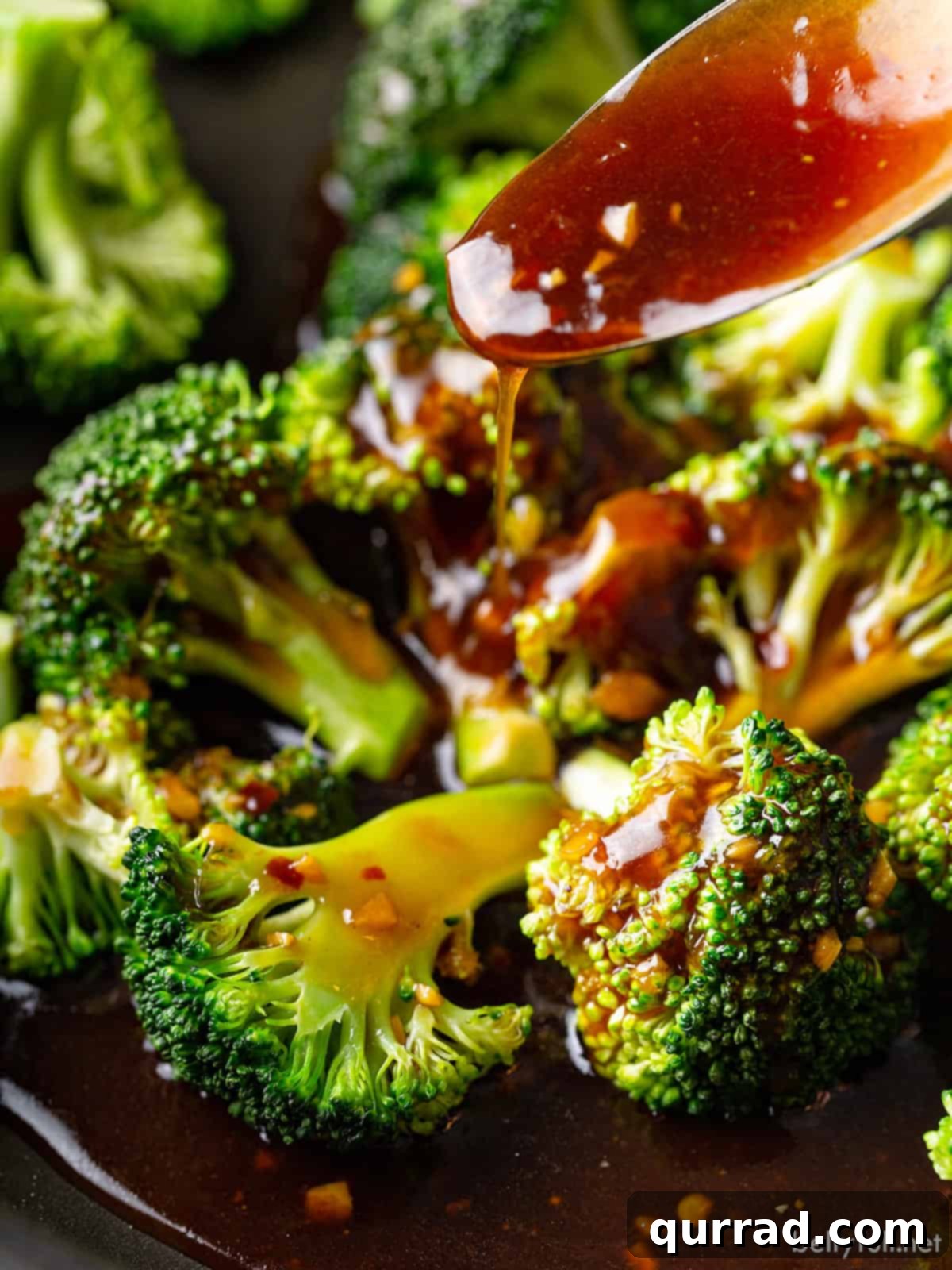 Essential Stir Fry Base 6 Thickened stir fry sauce being generously poured over a serving of perfectly sautéed broccoli and other vegetables, illustrating its application.