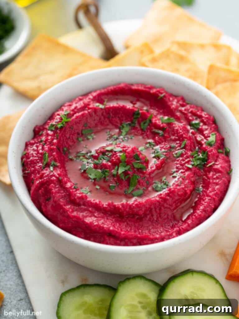 Vibrant Beetroot Hummus 2 side angle homemade beet hummus on white serving bowl