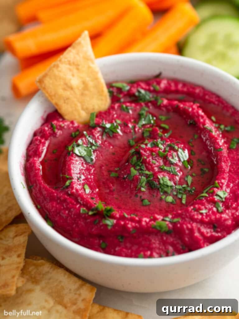 Vibrant Beetroot Hummus 4 hummus with beets in serving dish with pita chip