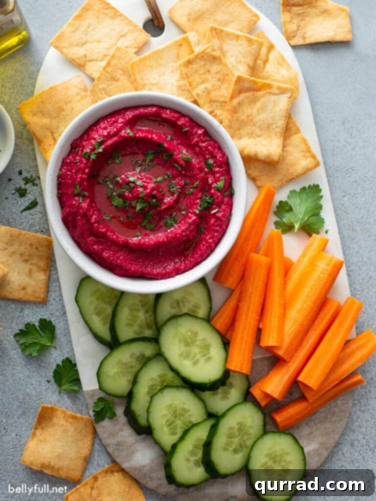 Vibrant Beetroot Hummus 5 overhead beet hummus in white dish surrounded by veggie sticks and pita crackers