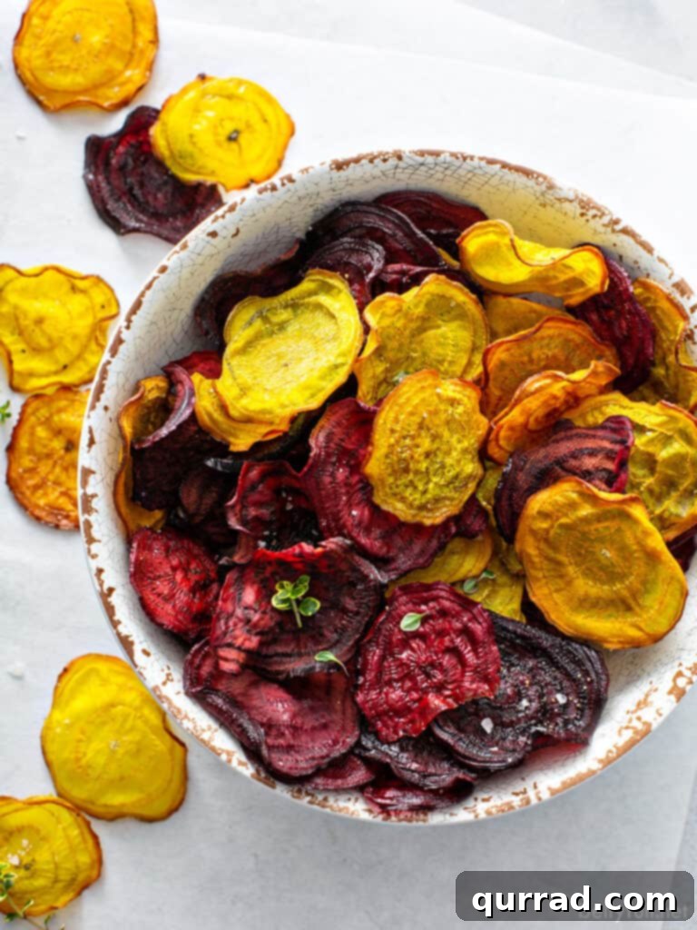 Crispy Beetroot Snaps 2 Overhead view of perfectly baked red and golden beet chips, artistically arranged in a rustic bowl, highlighting their vibrant colors and crisp texture.