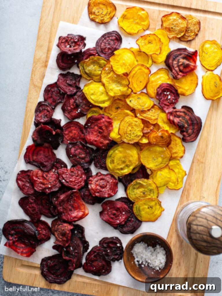 Crispy Beetroot Snaps 3 Close-up of vibrant red and golden beet slices arranged on parchment paper, ready for baking, showcasing their natural beauty and uniform thickness.