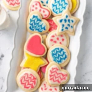 decorated cookies in blue, pink, and yellow sugar cookie icing
